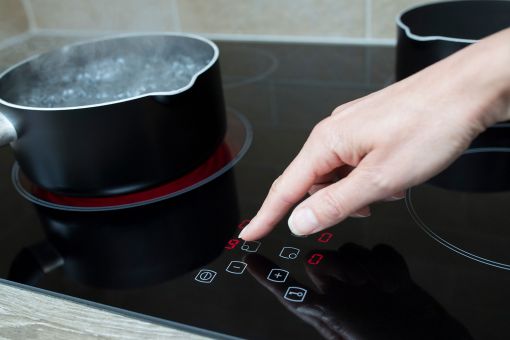 Woman using an electric hob