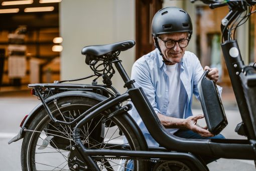 Man fitting a battery to an e-bike